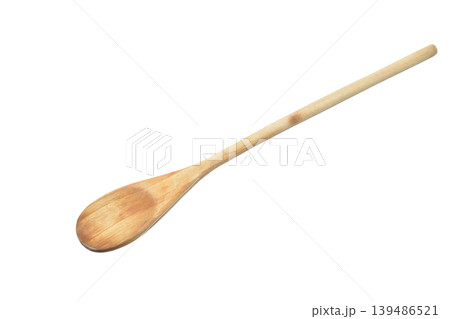 A wooden kitchen spoon with a long handle 139486521