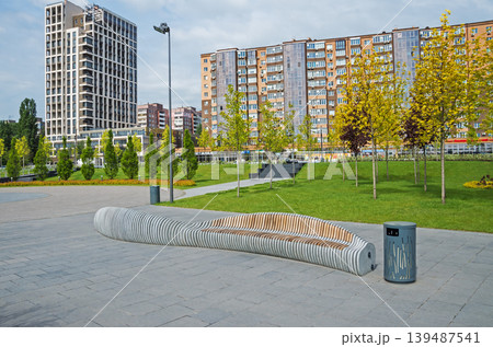 Twisted combined wood and granite bench in city park Twisted combined wood and granite bench in city park 139487541
