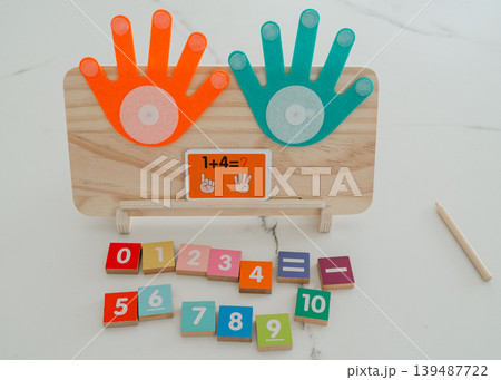 Math board showing a completed addition task with colorful number blocks. Helps children understand results and improve basic arithmetic skills. 139487722