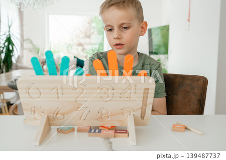 Educational toy designed for learning numbers and addition. The image highlights creative teaching methods for children. Educational toy designed for learning numbers and addition. The image highlights creative teaching methods for children. 139487737