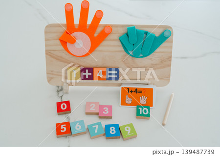 Wooden math board displaying a simple addition example with colorful number blocks. Designed for early education and interactive learning. Wooden math board displaying a simple addition example with colorful number blocks. Designed for early education and interactive learning. 139487739