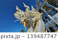 The Glimmering Guardian Majestic Silver and Gold Naga Under a Deep Blue Sky 139487747