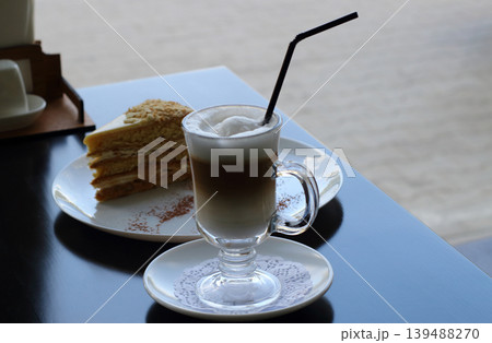 Napoleon cake and cappuccino on the wooden table at tea room Napoleon cake and cappuccino on the wooden table at tea room 139488270