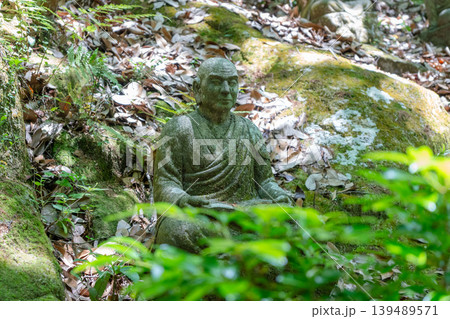 Monk statue in serene Mitaki-Dera temple garden in Hiroshima Monk statue in serene Mitaki-Dera temple garden in Hiroshima 139489571