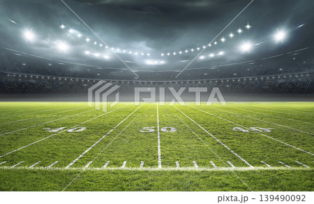 Illuminated American Football Field at Night in a Stadium Illuminated American Football Field at Night in a Stadium 139490092