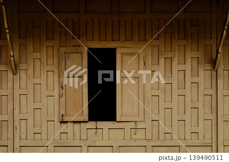 thai style woody wall with window made from a plank of wood thai style woody wall with window made from a plank of wood 139490511