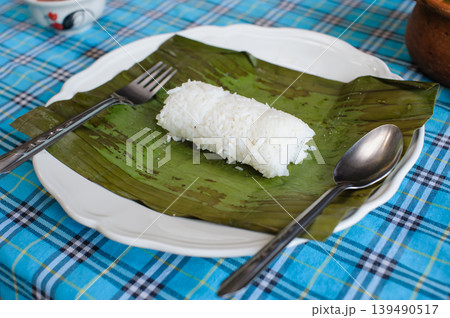 steamed rice with banana leaf spoon and folk on a dish 139490517