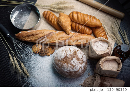 many type of bread studio shot with  ingredients flour seed  grain all aroundphoto take with high iso may has some noise and gain.many type of bread studio shot with  ingredients flour seed  grain 139490530