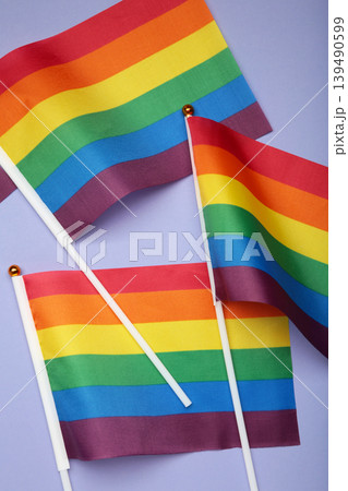 LGBT rainbow flag flat lay on purple background. Space for text. Vertical photo 139490599