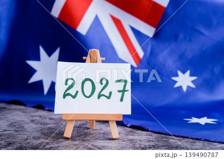 Australian flag and text 2027 trendy template for upcoming year campaigns. Patriotic design marking 2027 beside national flag. Concept of future vision and planning ideal for annual report or goal Australian flag and text 2027 trendy template for upcoming year campaigns. Patriotic design marking 2027 beside national flag. Concept of future vision and planning ideal for annual report or goal 139490787