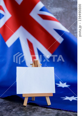 Mock-up for custom copy designs. Clean empty message board next to Australian flag. Place your logo or text on the white paper board next to the Australian flag. Modern mock-up template with national 139490800