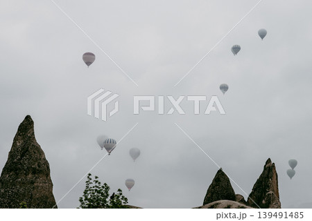 Air balloon flight early morning dawn cloudy sky mountain rock Cappadocia Turkey 139491485