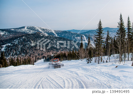 Snowcat cleans ski track at ski resort in winter Sheregesh, Siberia, Russia 139491495