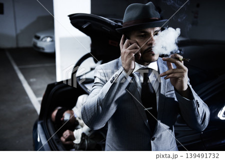 Mafia, car and man with hostage in trunk for negotiation, kidnapping ransom and crime. Business, gangster criminal smoking and person in boot for abduction, danger and robbery in parking lot or smoke 139491732