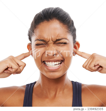 Face, sound and fingers in ears with an eyes closed woman in studio isolated on a white background. Stress, anxiety or loud with a frustrated young person feeling unhappy or overwhelmed by noise Face, sound and fingers in ears with an eyes closed woman in studio isolated on a white background. Stress, anxiety or loud with a frustrated young person feeling unhappy or overwhelmed by noise 139492335
