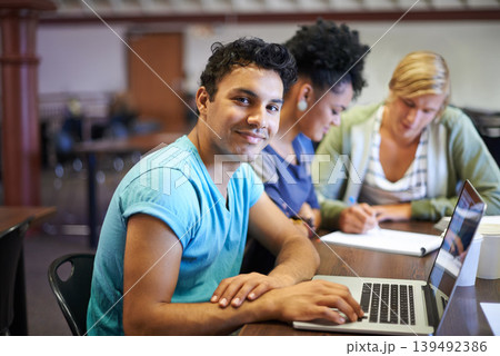Portrait of man, laptop or students in library studying for education in university, college or school. Smile, elearning or people with scholarship on campus reading news, research or online course Portrait of man, laptop or students in library studying for education in university, college or school. Smile, elearning or people with scholarship on campus reading news, research or online course 139492386