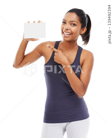 Woman, card and portrait of pointing to blank advertising, poster or mock up space in white background of studio. Indian, model and hand gesture to sign, post and paper for promotion or information 139492394