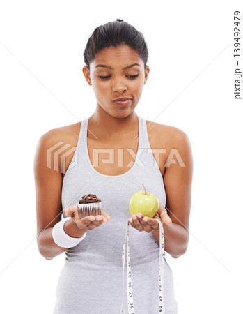 Woman, dessert and apple thinking in studio for diet weightloss choice, healthy eating or white background. Female person, fruits and cupcake decision for nutrition food, wellness or mockup space Woman, dessert and apple thinking in studio for diet weightloss choice, healthy eating or white background. Female person, fruits and cupcake decision for nutrition food, wellness or mockup space 139492479