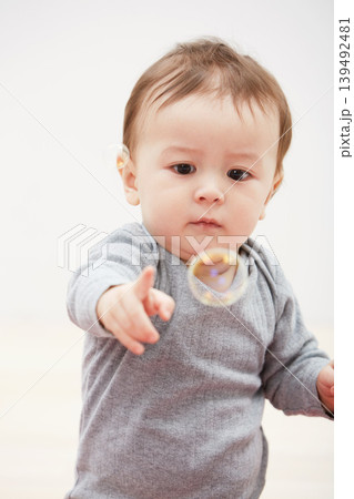 Baby, bubbles and playing game for fun childhood development, curious wondering or education. Kid, growth and mockup space for learning progress or sensory, coordination skill or youth entertainment 139492481