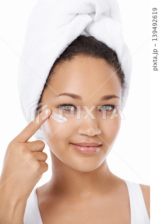 Young woman, face and beauty cream, skincare and cosmetics on a white background. Portrait of an African model or person with moisturizer application, skin care product and dermatology in studio Young woman, face and beauty cream, skincare and cosmetics on a white background. Portrait of an African model or person with moisturizer application, skin care product and dermatology in studio 139492619