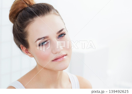 Skincare, portrait and woman in a bathroom with cosmetics, wellness or glowing skin treatment at home. Beauty, face and female person in a house with shine, dermatology or natural makeup results Skincare, portrait and woman in a bathroom with cosmetics, wellness or glowing skin treatment at home. Beauty, face and female person in a house with shine, dermatology or natural makeup results 139492625