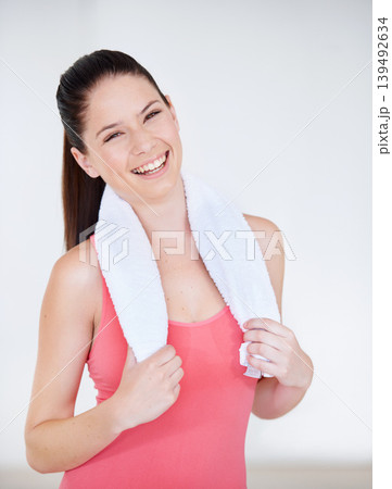 Portrait of athlete, gym or happy woman with towel for fitness or wellness with confidence. Smile, model laughing or healthy sports person ready to start workout, training or exercise with energy 139492634