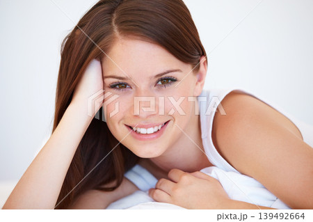 Smile, beauty and portrait of woman on bed for relaxing with positive, good and confident attitude. Happy, calm and young female person from Canada laying and resting in bedroom of modern apartment. Smile, beauty and portrait of woman on bed for relaxing with positive, good and confident attitude. Happy, calm and young female person from Canada laying and resting in bedroom of modern apartment. 139492664