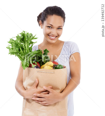 Vegetables, shopping portrait and happy woman in studio for healthy food, sustainability or diet. Young person, customer or model with bag of groceries for discount or nutrition on a white background 139492712
