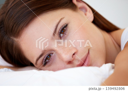 Portrait, wellness and bedroom with woman, relax and resting with weekend break, home and awake. Face, person and apartment with girl, pillow and peace with cushion, happy and blanket with health 139492806