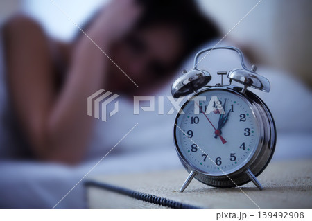Alarm, clock and frustrated woman in a bed with hands on ears for noise, sound or alert at home. Time, bell and female person in a bedroom blur with fatigue, burnout or sleeping late from insomnia Alarm, clock and frustrated woman in a bed with hands on ears for noise, sound or alert at home. Time, bell and female person in a bedroom blur with fatigue, burnout or sleeping late from insomnia 139492908