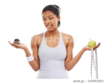 Woman, apple and cupcake decision for diet in studio for weight loss choice, healthy eating or white background. Female person, fruit and dessert thinking for nutrition food, balance or mockup space Woman, apple and cupcake decision for diet in studio for weight loss choice, healthy eating or white background. Female person, fruit and dessert thinking for nutrition food, balance or mockup space 139492920