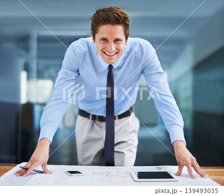 Architect, man and smile in portrait, blueprint and project management or designing floor plan in office. Male professional, construction and contractor for home renovation or real estate buildings Architect, man and smile in portrait, blueprint and project management or designing floor plan in office. Male professional, construction and contractor for home renovation or real estate buildings 139493035