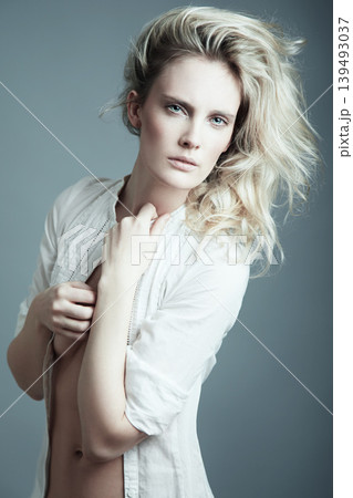 Woman, portrait and beauty in fashion or natural skincare isolated against a gray studio background. Face of attractive young female person or model posing with hairstyle, t shirt or cool clothing 139493037