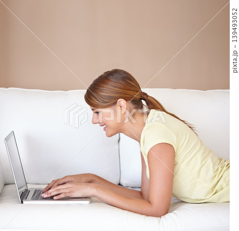 Woman, smile or typing on laptop at sofa to update blog post, social media or digital subscription for remote work. Profile, happy freelancer or computer for online shopping, email or relax at mockup Woman, smile or typing on laptop at sofa to update blog post, social media or digital subscription for remote work. Profile, happy freelancer or computer for online shopping, email or relax at mockup 139493052