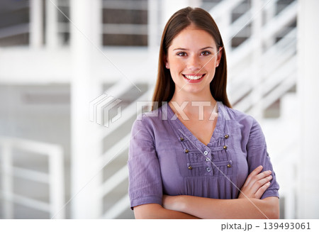 Portrait, smile and a business woman arms crossed in her office as a company intern at the start of her career. Mindset, confident and a happy young employee in a creative agency as a designer Portrait, smile and a business woman arms crossed in her office as a company intern at the start of her career. Mindset, confident and a happy young employee in a creative agency as a designer 139493061
