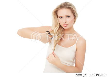 Scissors, woman and portrait of hair care choice and decision with doubt and confused in studio. Cosmetics, diy and female person with haircut for split ends with treatment and white background Scissors, woman and portrait of hair care choice and decision with doubt and confused in studio. Cosmetics, diy and female person with haircut for split ends with treatment and white background 139493082