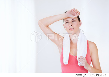 Gym, space or tired athlete sweating in exercise, fitness training or workout break in studio. Healthy, fatigue or exhausted woman breathing on white background for sports or running performance Gym, space or tired athlete sweating in exercise, fitness training or workout break in studio. Healthy, fatigue or exhausted woman breathing on white background for sports or running performance 139493123