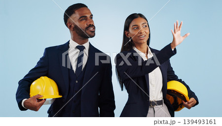 Business people, architect and planning in vision for building or construction against a blue studio background. Man and woman in engineering or project plan with hard hat for safety on mockup space 139493161