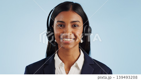 Happy woman, portrait and headphones for call center or telemarketing against a blue studio background. Face of female person, consultant or agent smile with mic for online advice on mockup space Happy woman, portrait and headphones for call center or telemarketing against a blue studio background. Face of female person, consultant or agent smile with mic for online advice on mockup space 139493208