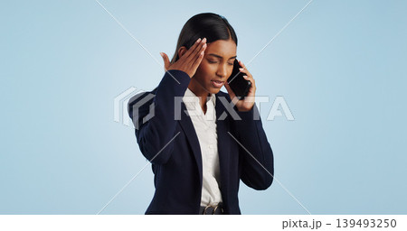 Business, phone call and woman with stress, headache and employee isolated on a blue studio background. Mockup space, person and entrepreneur with a cellphone, connection and frustrated with migraine Business, phone call and woman with stress, headache and employee isolated on a blue studio background. Mockup space, person and entrepreneur with a cellphone, connection and frustrated with migraine 139493250