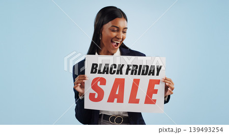 Business woman, sale and sign for discount, advertising or deal against a blue studio background. Shocked female person with billboard, poster or wow for marketing, promotion or Black Friday special 139493254