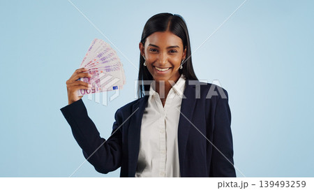 Happy business woman, portrait and money fan in financial freedom against a blue studio background. Excited female person or employee with cash, savings or investment for bonus salary on mockup space Happy business woman, portrait and money fan in financial freedom against a blue studio background. Excited female person or employee with cash, savings or investment for bonus salary on mockup space 139493259