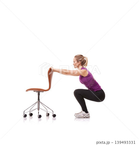 Pilates, exercise and woman squat with chair or crouch in white background or studio. Stretching, body and person in workout with a seat for fitness, health and wellness practice for posture 139493331
