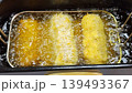 Deep Frying Breaded Crispy Snacks in Boiling Oil in Professional Fryer 139493367