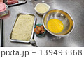 Ingredients Preparation for Breading Food with Breadcrumbs and Beaten Eggs in Kitchen 139493368
