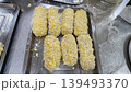 Raw Breaded Meat Rolls with Panko Breadcrumbs on a Stainless Steel Tray Prepared for Deep Frying 139493370