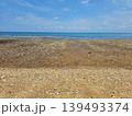 Wide Angle View of Pebble Stone Beach and Calm Blue Sea Under Clear Sky 139493374
