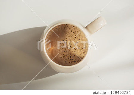 Top View on Frothy Coffee in Ceramic Mug. Cozy Morning Flatlay Top View on Frothy Coffee in Ceramic Mug. Cozy Morning Flatlay 139493784