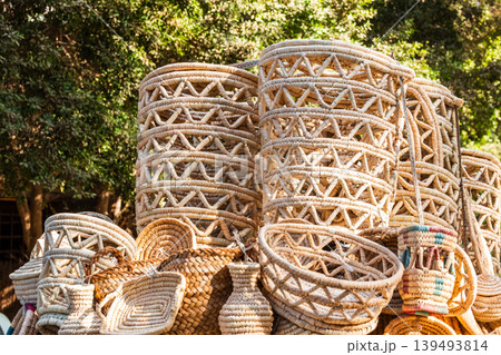 Traditional woven baskets made from palm leaves in Egypt. Various shapes and sizes are displayed, showcasing intricate craftsmanship and natural materials. Traditional woven baskets made from palm leaves in Egypt. Various shapes and sizes are displayed, showcasing intricate craftsmanship and natural materials. 139493814