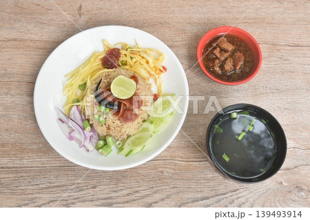 fried rice mixed with shrimp paste eat couple egg and vegetable on plate dressing sweet pork gravy eat couple clear soup fried rice mixed with shrimp paste eat couple egg and vegetable on plate dressing sweet pork gravy eat couple clear soup 139493914